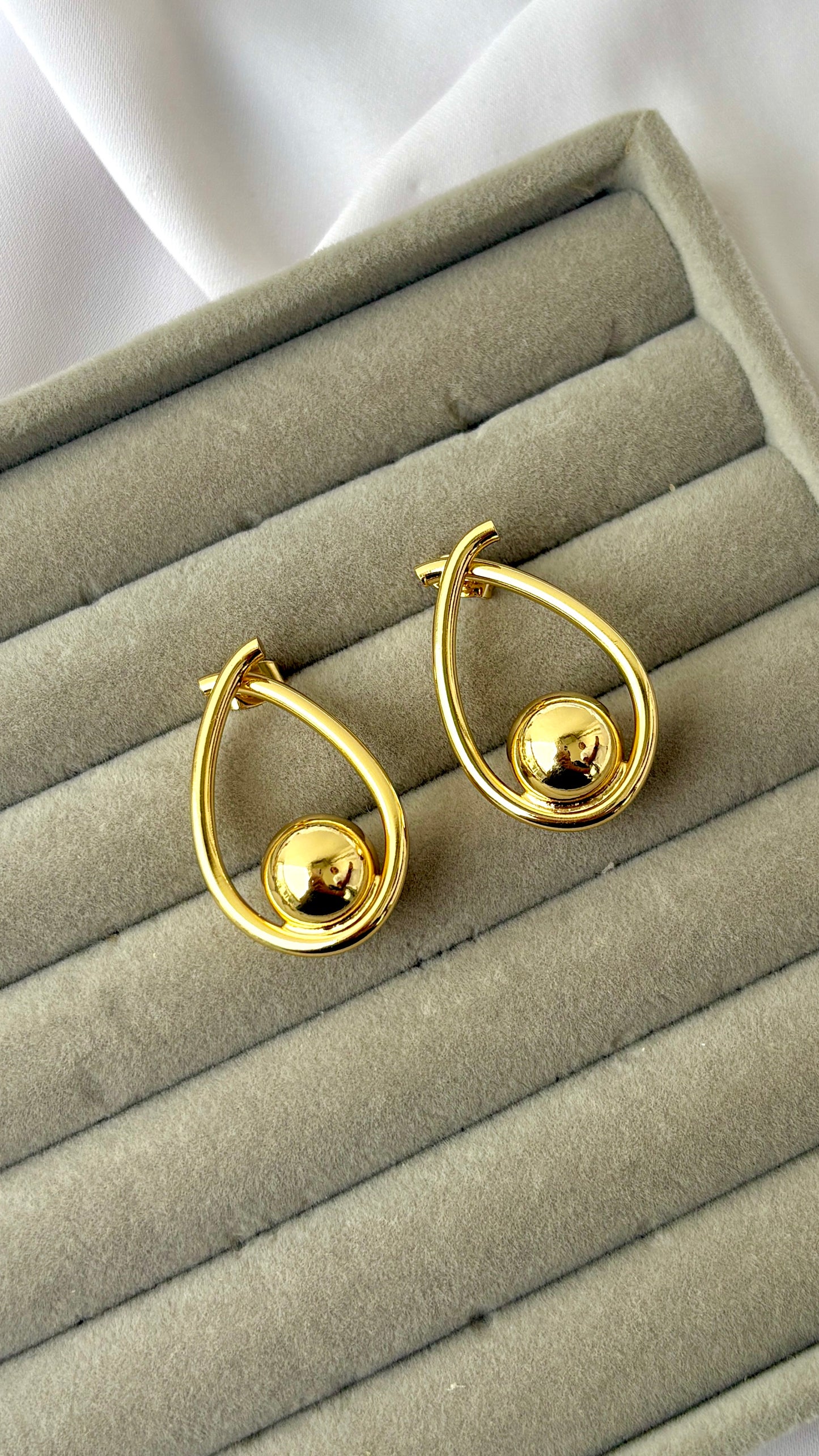 Golden ball in an oval dangler