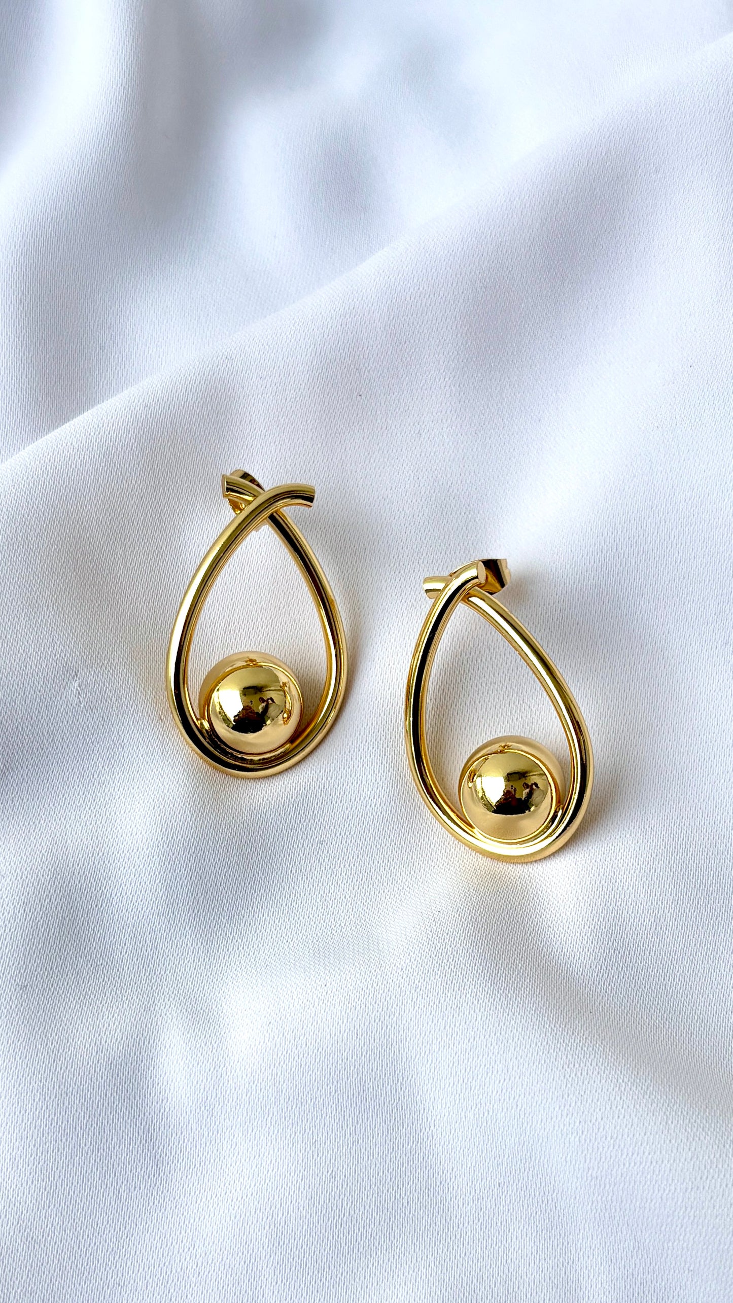 Golden ball in an oval dangler