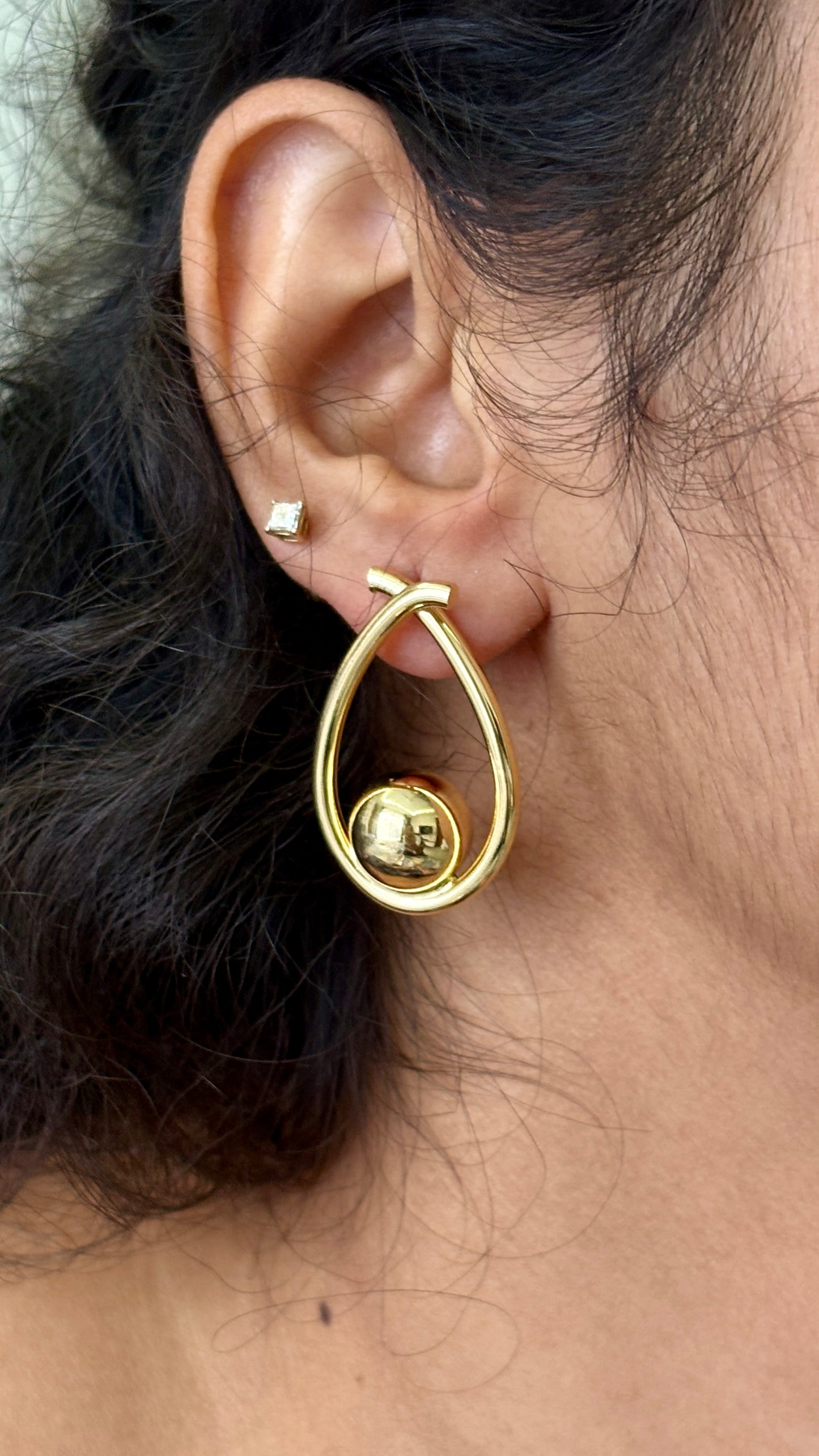 Golden ball in an oval dangler