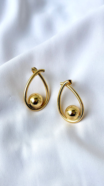 Golden ball in an oval dangler